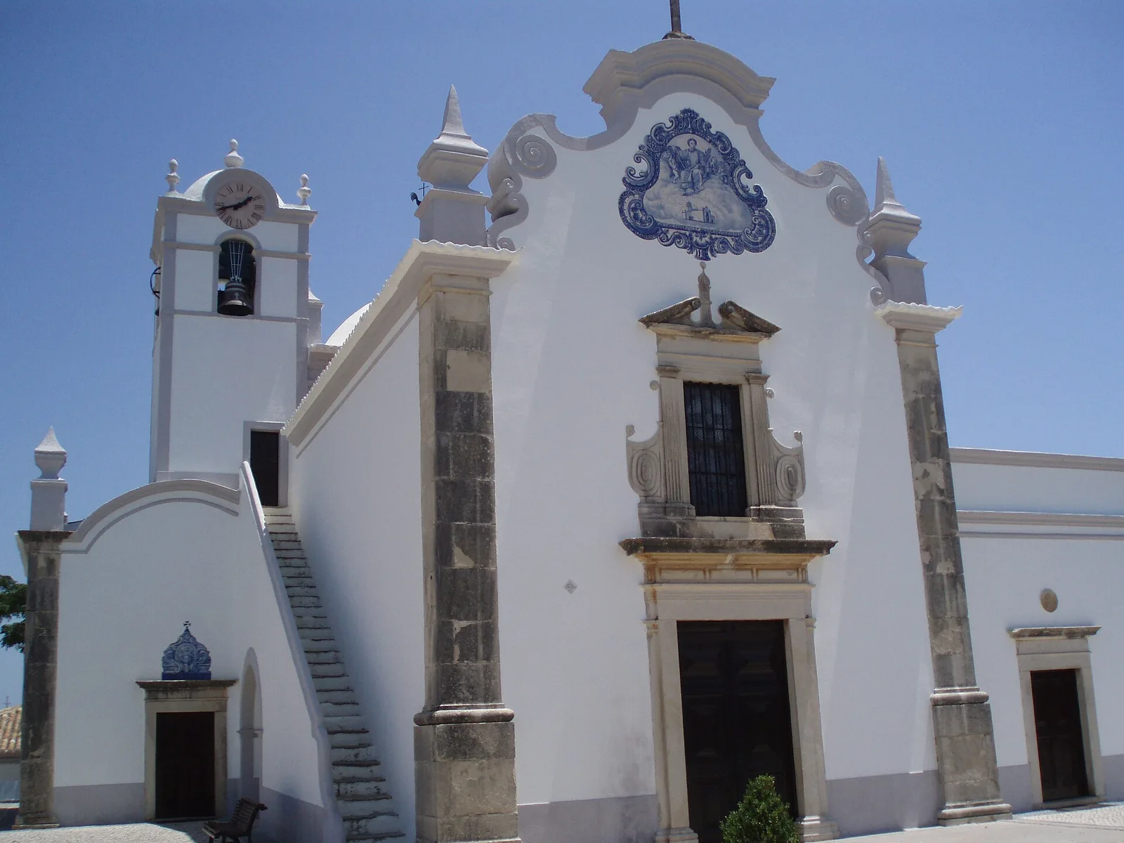 The white facade and bell tower of São Lourenço church near Almancil