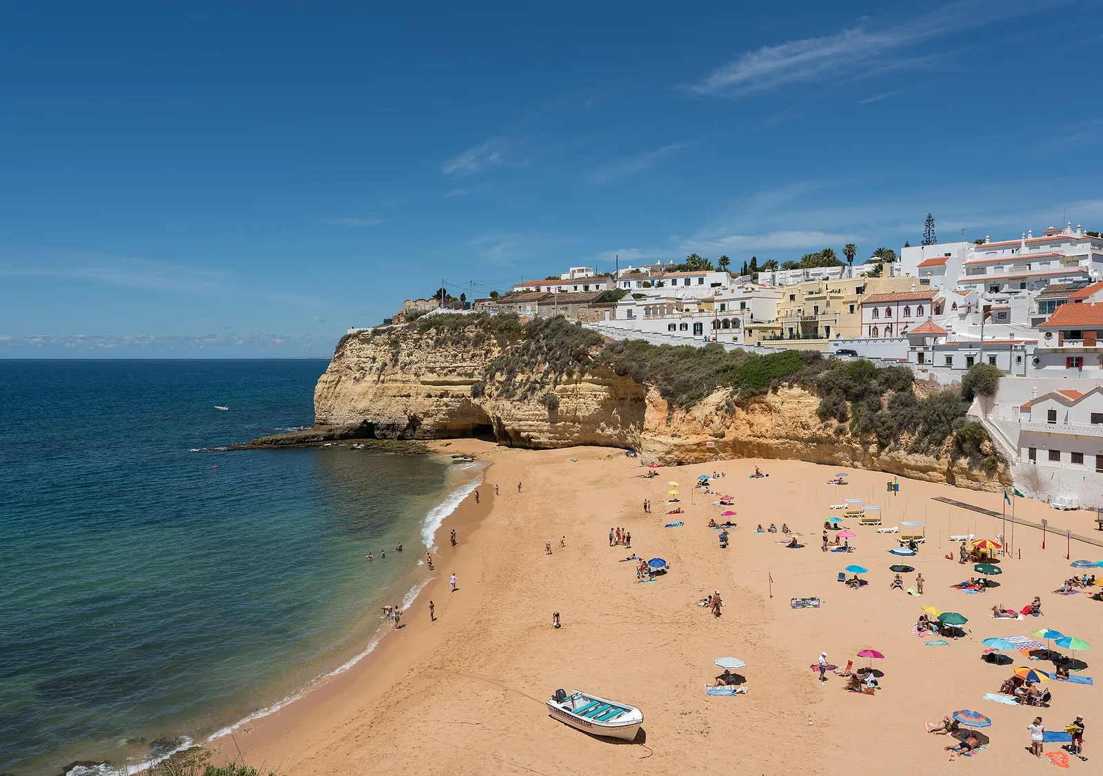 White buildings and golden cliffs above the beach at Carvoeiro