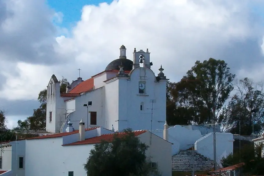 White Conceição chapel with red trim and twin turrets in Alcoutim