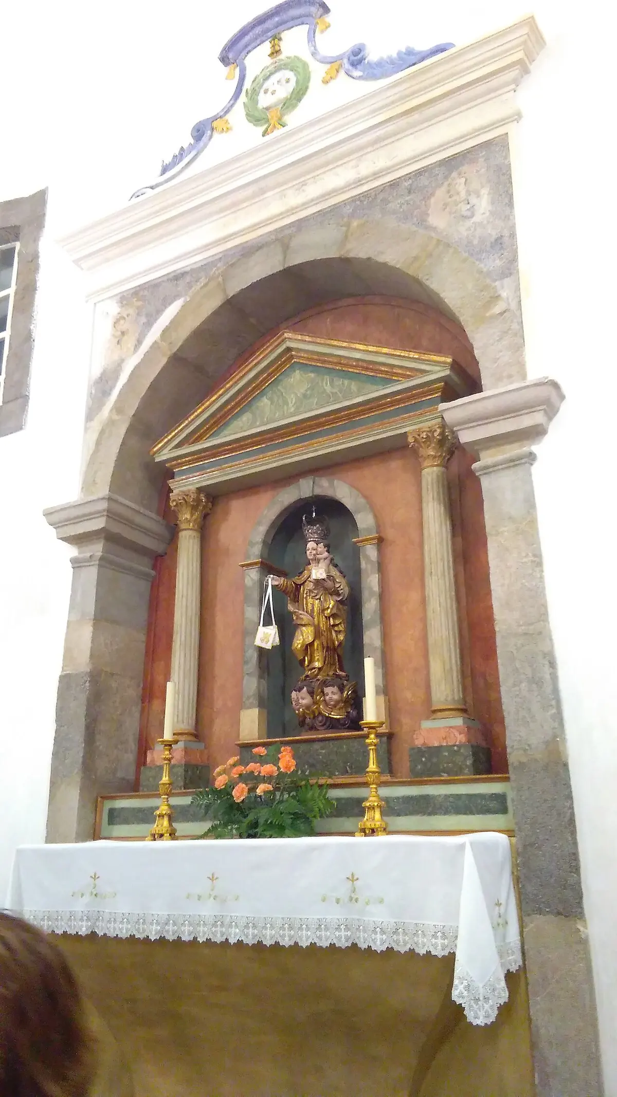 Carved altar and devotional figure inside the parish church of Cacela Velha