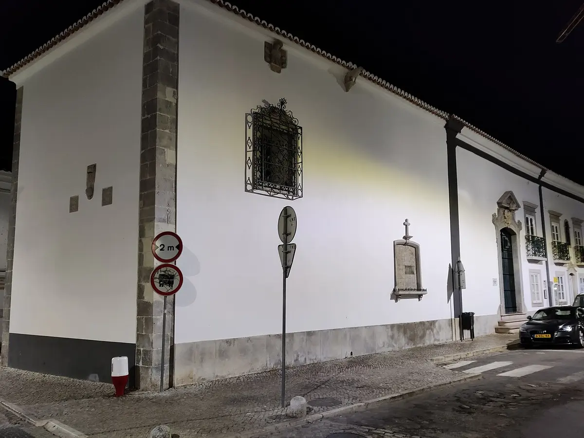 Night-time view of the white walls and portal of Nossa Senhora das Ondas in Tavira