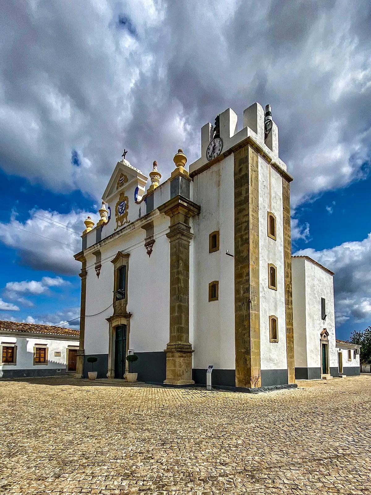 White parish church with twin square towers in Pechão