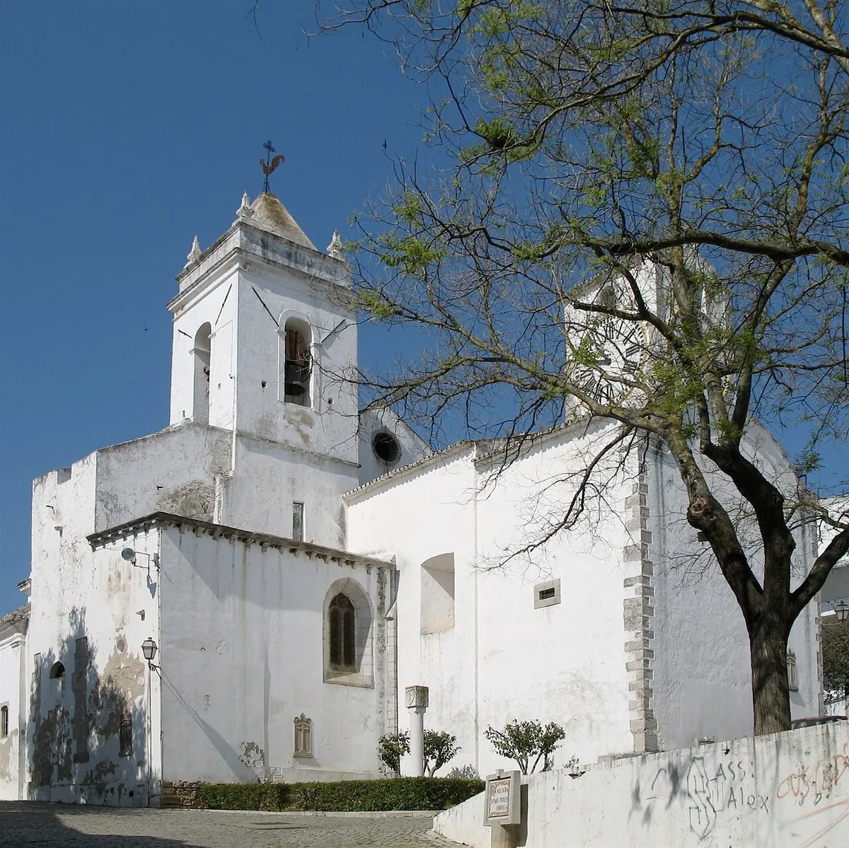 White church walls and square bell tower of Santa Maria do Castelo in Tavira