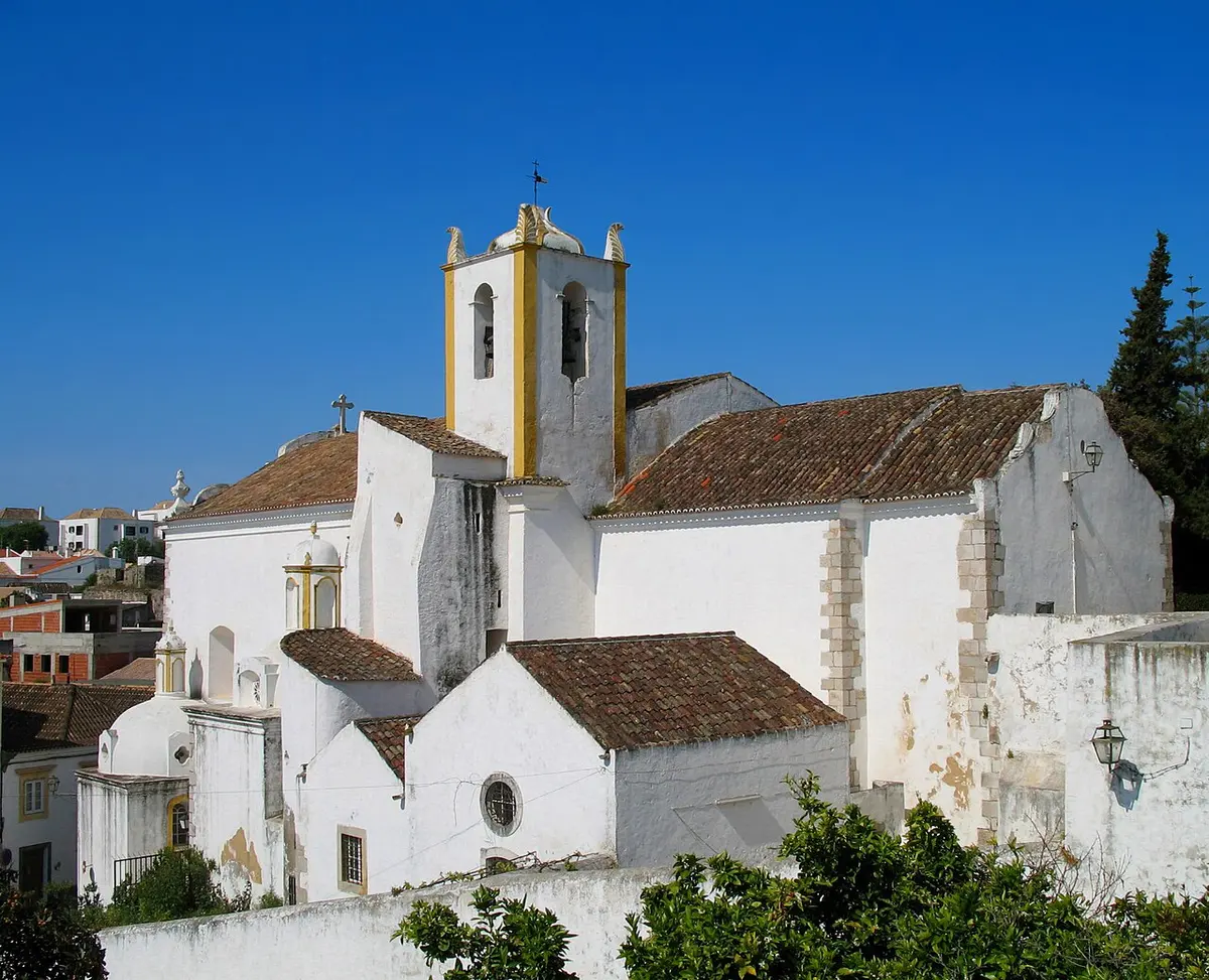 Igreja de Santiago with its bell tower and tiled roofs on Tavira’s hill