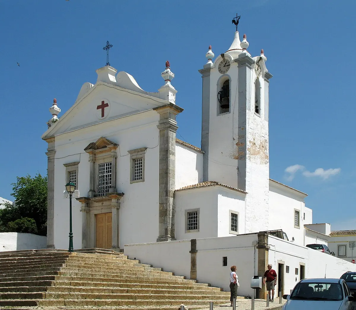 White parish church and bell tower at the top of the steps in Estoi