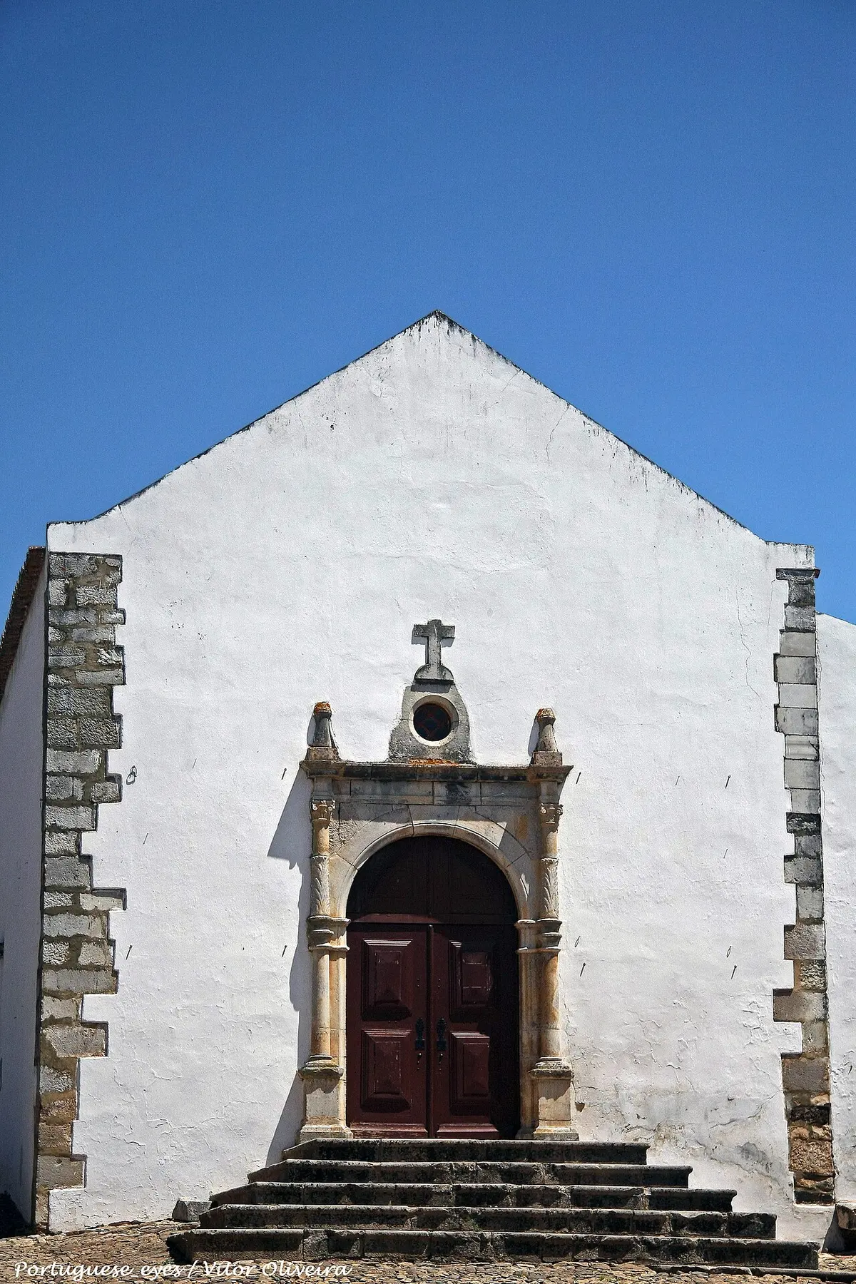 Gabled entrance wall and stone doorway of the former Santiago church inside Castro Marim Castle