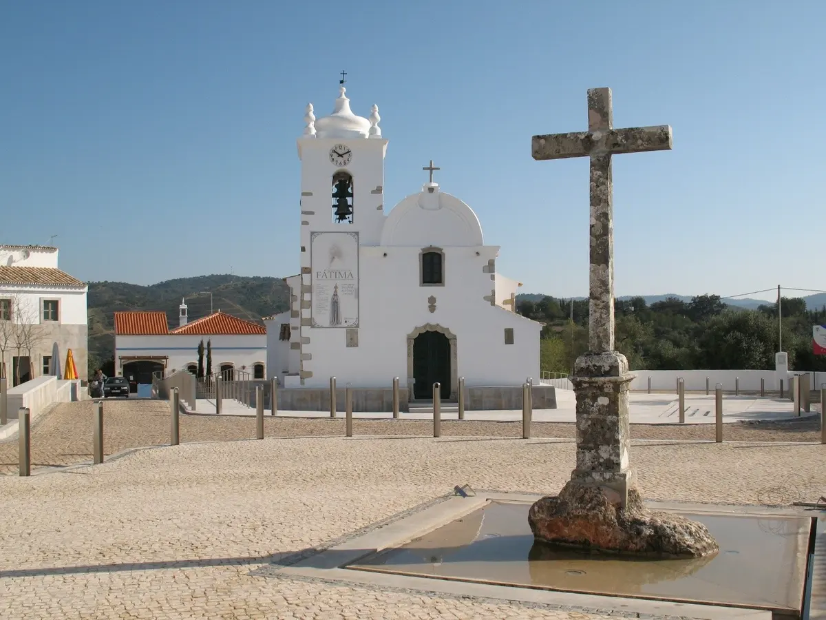 Querença parish church and the stone cross in its village square