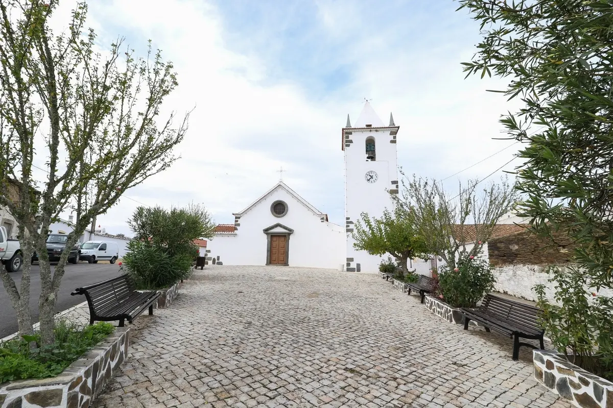 A paved village square leading towards Santo António church in Ameixial