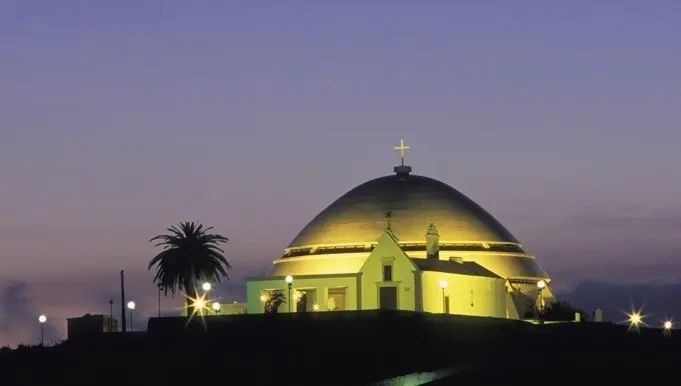 The illuminated dome of the modern Mãe Soberana sanctuary above Loulé