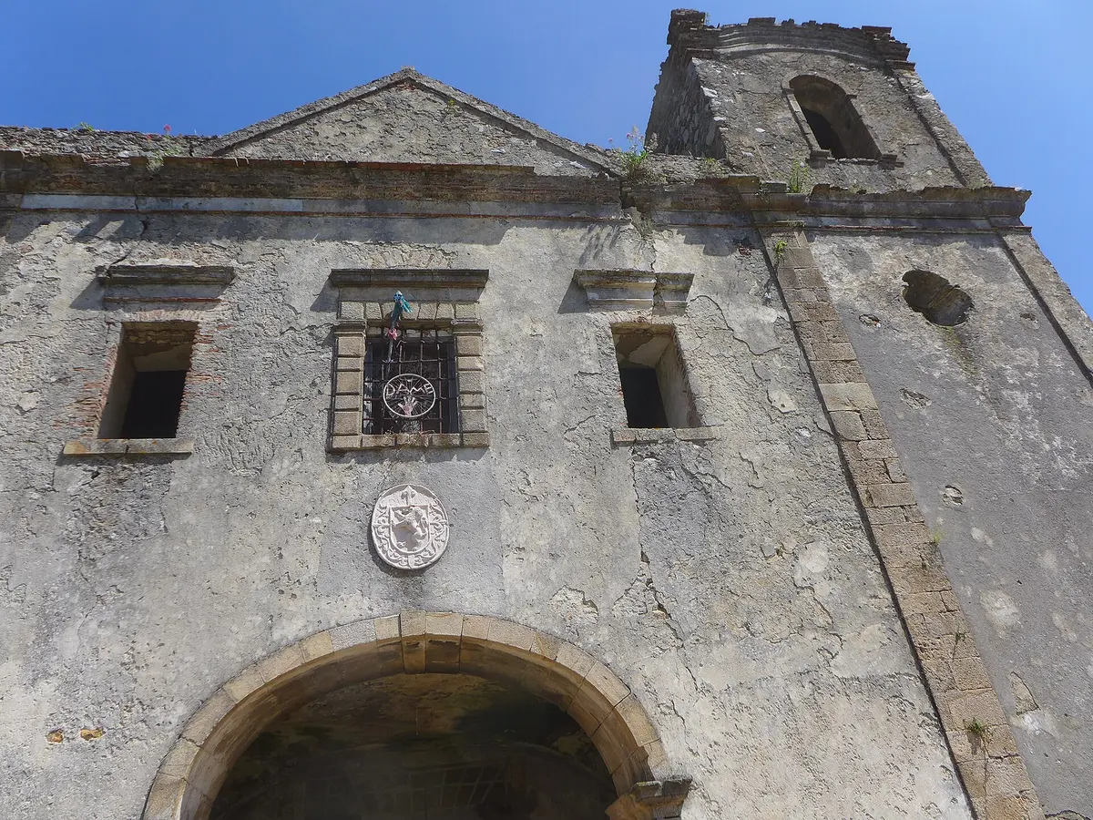 The weathered church façade and entrance arch of the ruined Desterro convent