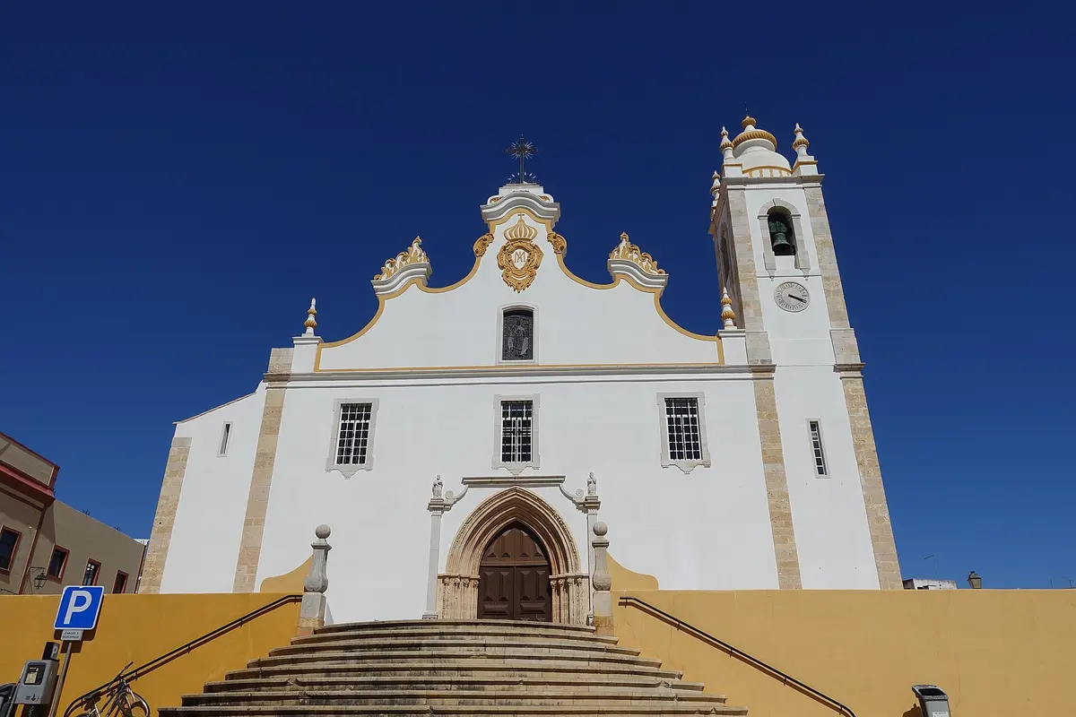 The main façade and twin towers of Portimão’s parish church above a broad stairway