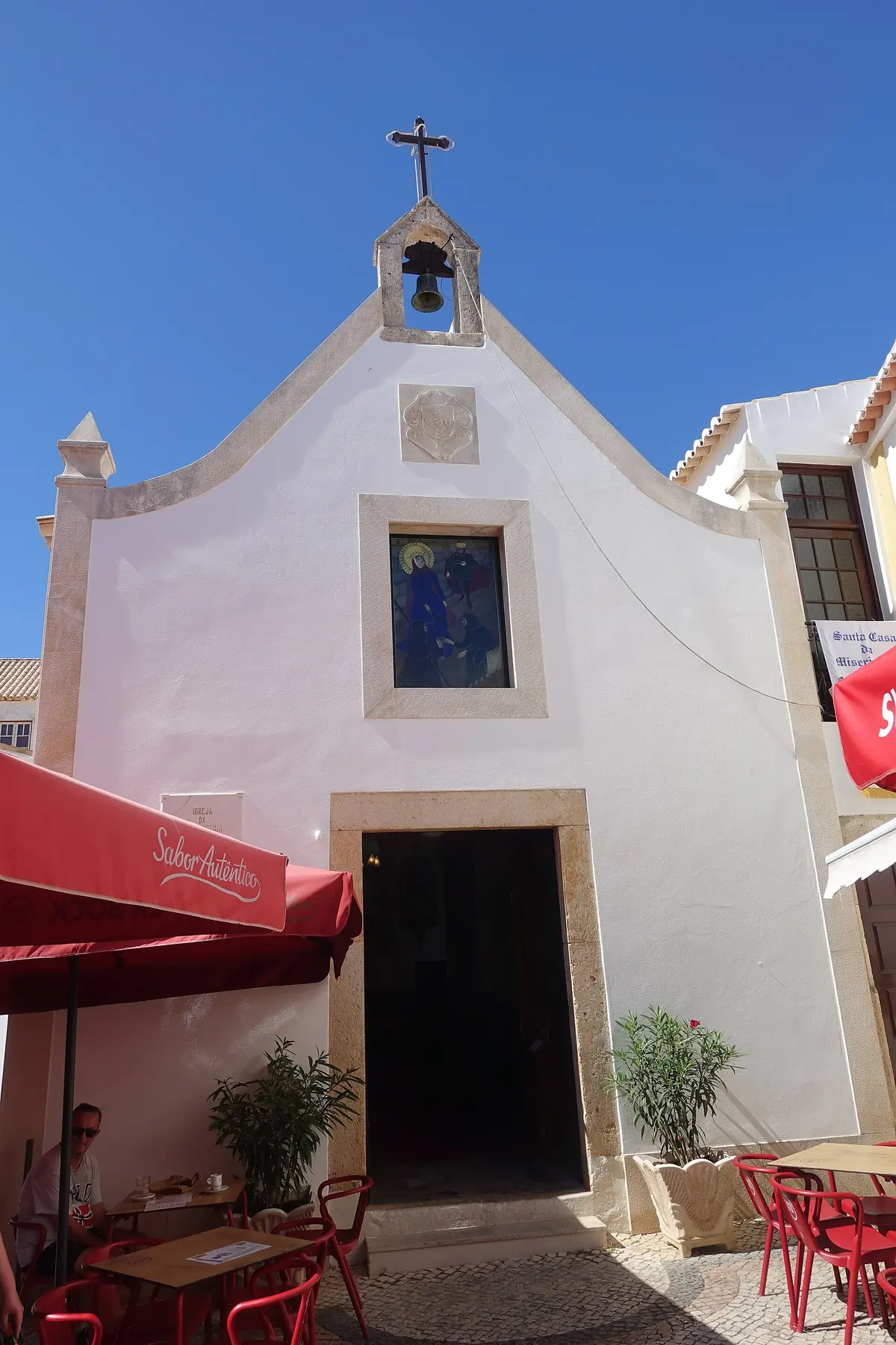 The narrow white façade and small bell gable of the Misericórdia church in Alvor
