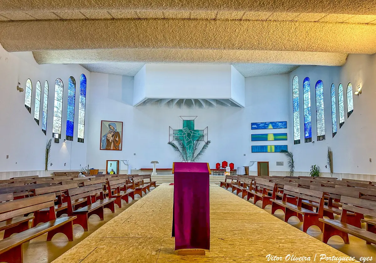 The modern sanctuary and rows of pews inside Nossa Senhora do Amparo church