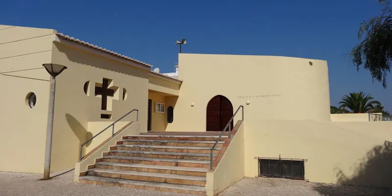 The ochre Burgau church entrance above a short flight of steps