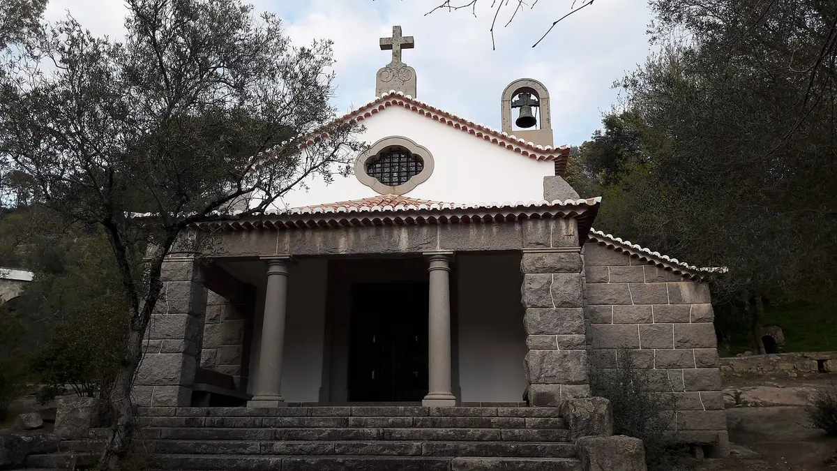 The porch and tiled roof of Santa Teresa chapel in the wooded Caldas de Monchique setting