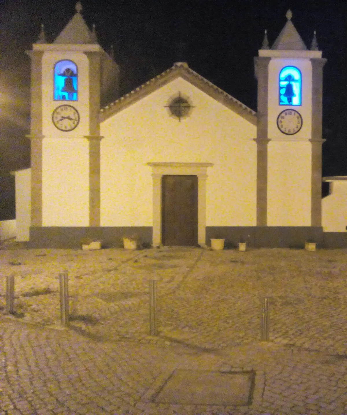 The illuminated village church of São João Baptista at night