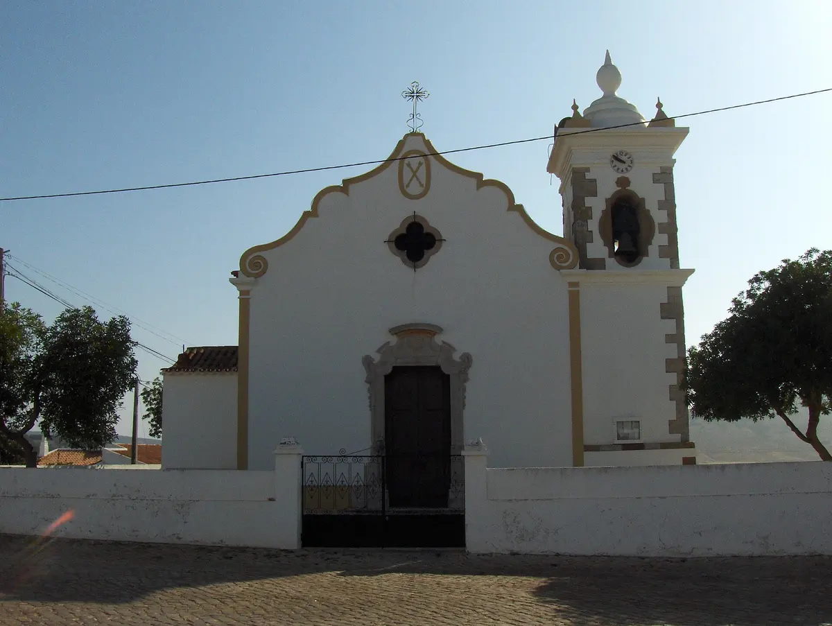 The pale façade and decorative stone doorway of São Sebastião church in Budens