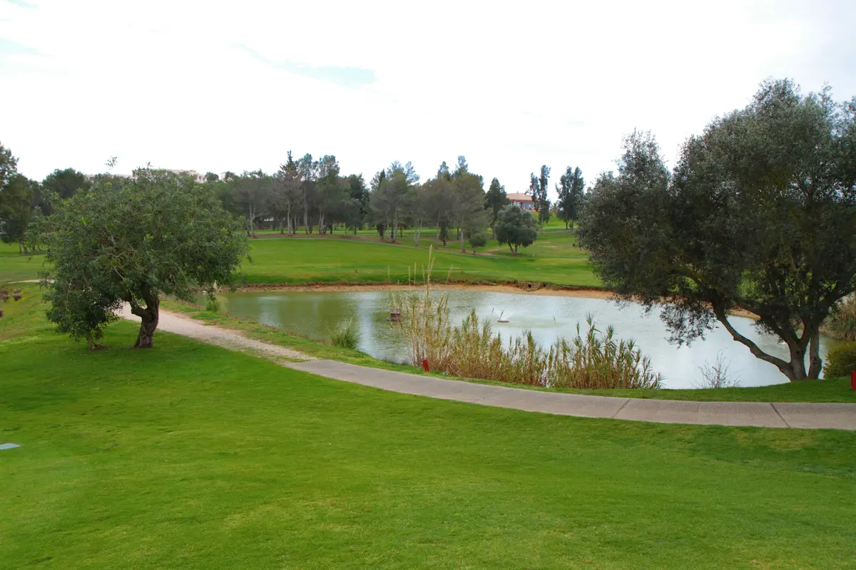 Pond and tree-lined fairway at Alto Golf near Alvor