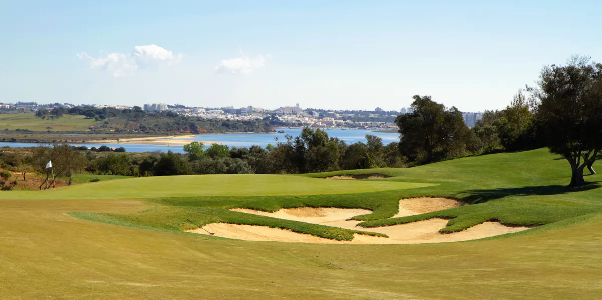 Bunkers and a green at Palmares Golf overlooking the coast and estuary