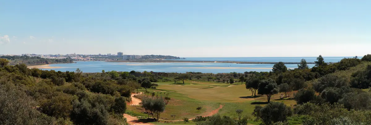 Wide view across Palmares fairways towards coastal water and sandbars