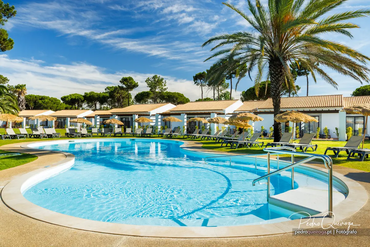 Curving outdoor pool, palms and hotel buildings at Pestana Vila Sol near Vilamoura