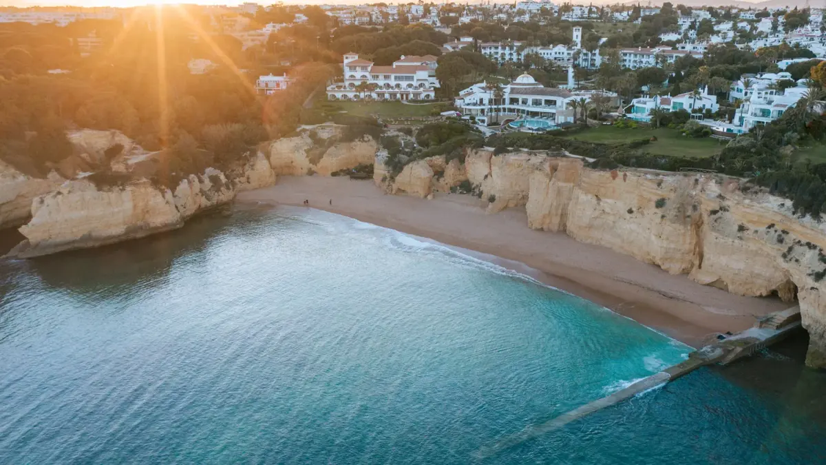 Vila Vita Parc resort buildings above the cliffs and sheltered coastal cove at Porches