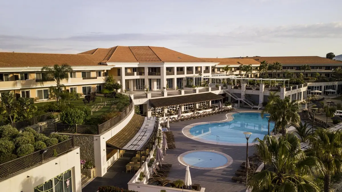 The hotel wings, terracotta roofs and curving outdoor pool of Wyndham Grand Algarve in Quinta do Lago