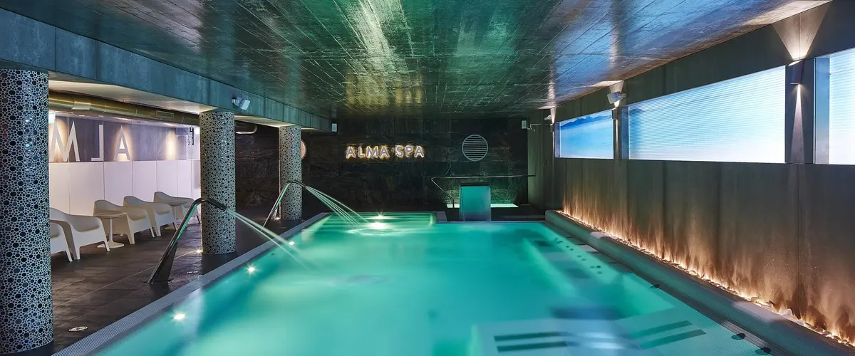 Indoor spa pool and lounge chairs at Alcazar Hotel in Monte Gordo