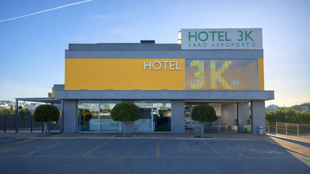 Yellow and grey entrance façade of Hotel 3K Faro near the airport