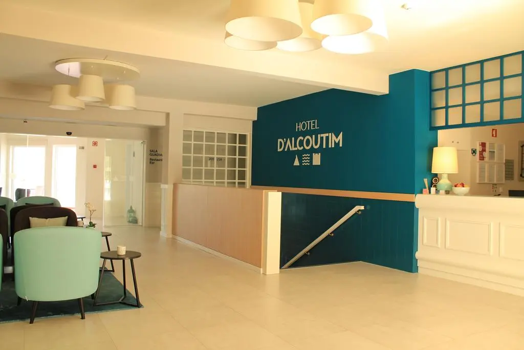 The reception at Hotel D'Alcoutim with a teal feature wall, pale desk and lounge seating