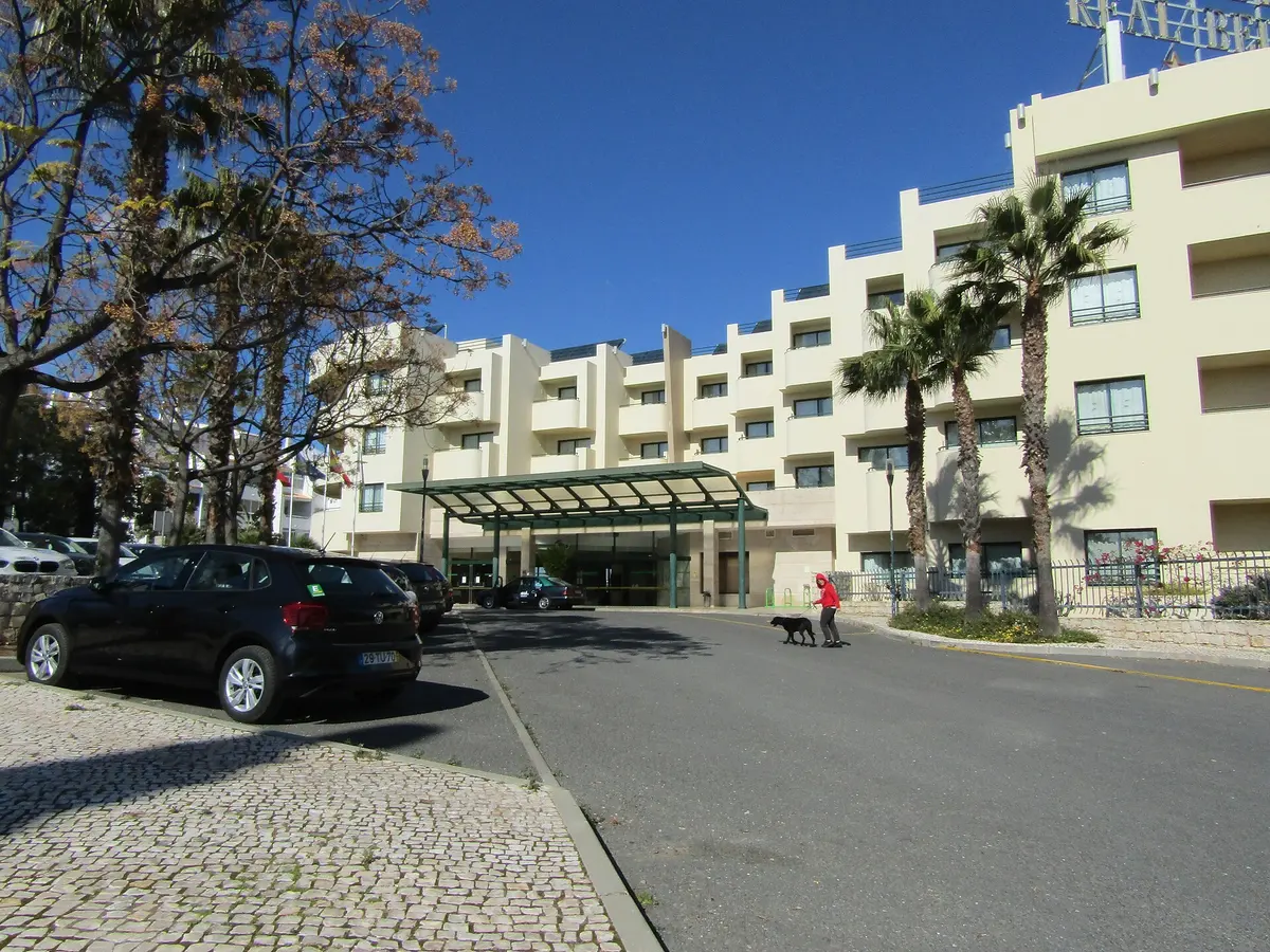 The curved pale facade and entrance of the former Real Bellavista hotel in Albufeira, now Holiday Inn Algarve Albufeira