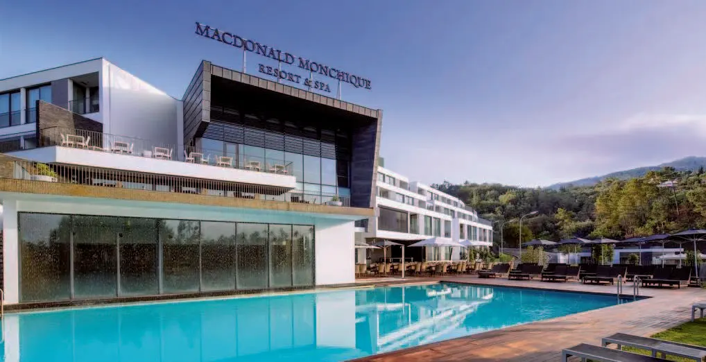 A blue outdoor pool below the white Monchique Resort hotel building with its former Macdonald name visible