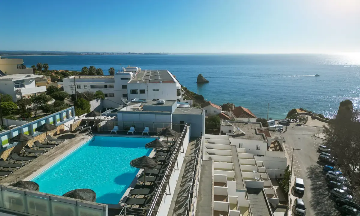 The rooftop pool and terrace at Carvi Beach Hotel with the Lagos coast beyond