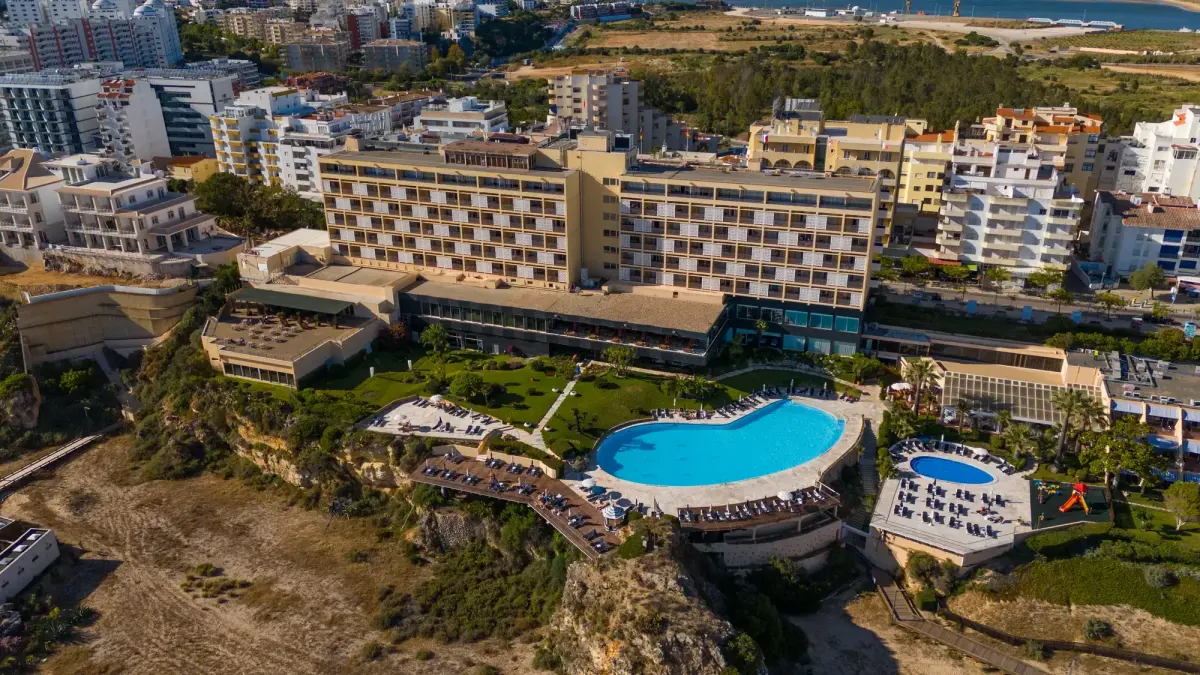 An aerial view of Hotel Algarve Casino, its pool terrace and Praia da Rocha
