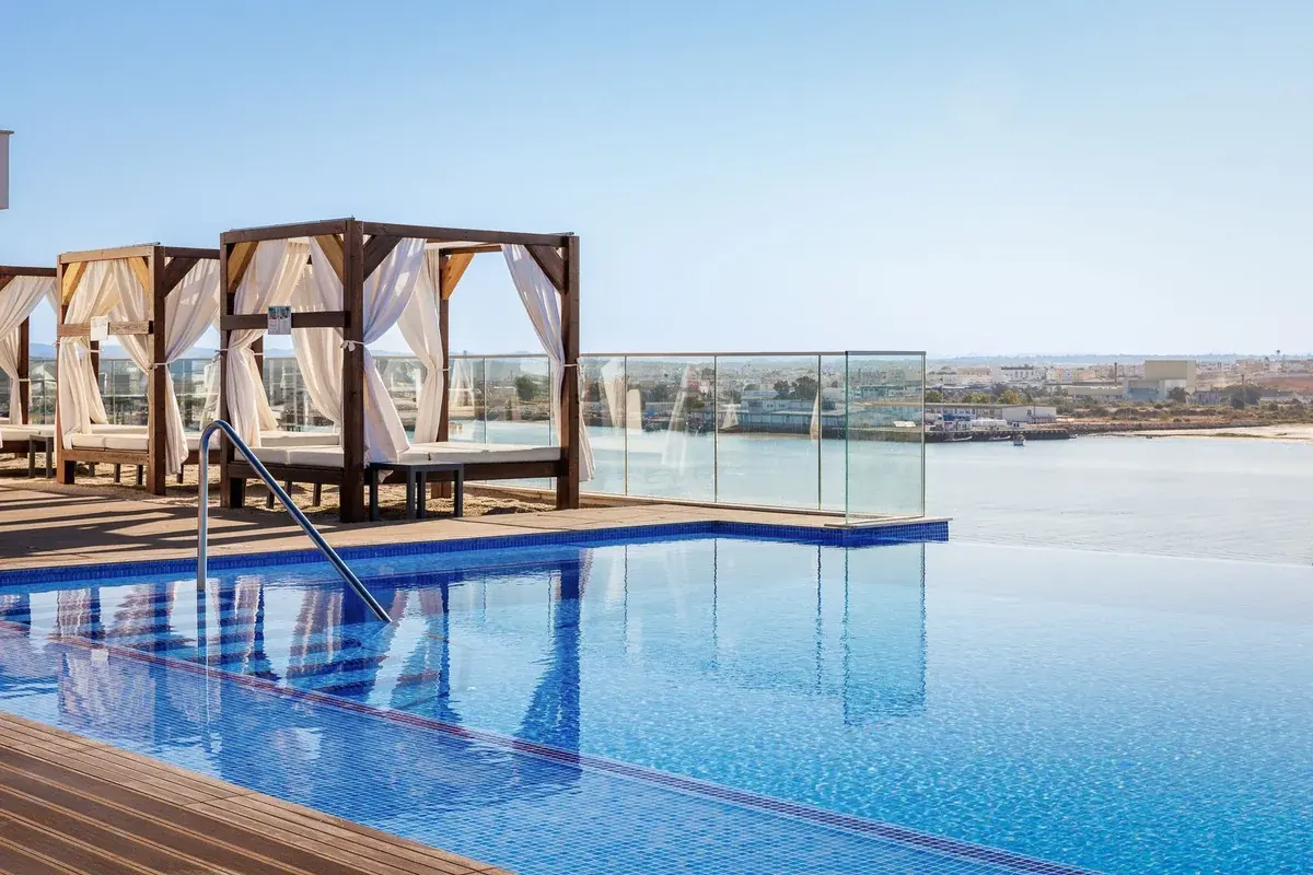 The rooftop pool, loungers and cabanas at Jupiter Marina Hotel