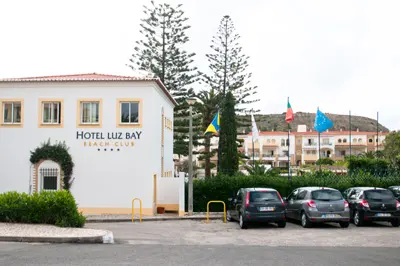 The signed entrance and buildings of Luz Bay Hotel