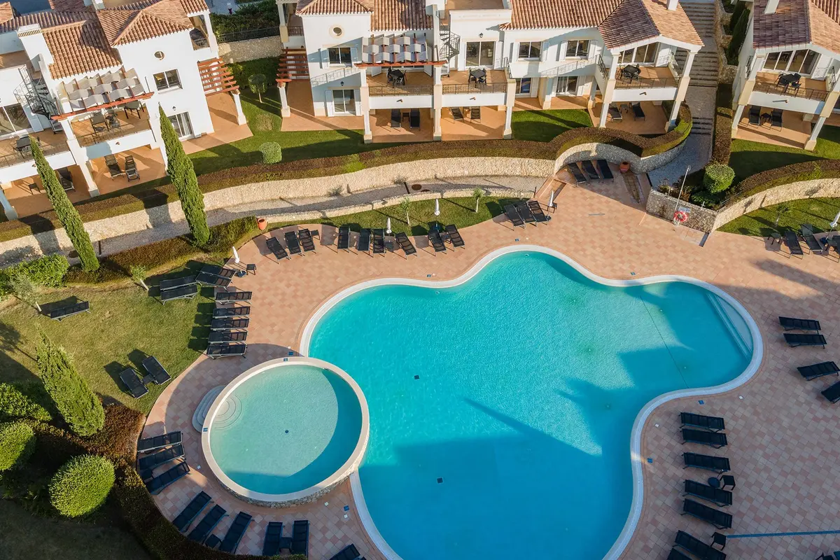 An elevated view of the swimming pool and surrounding houses at NAU Salema Beach Village