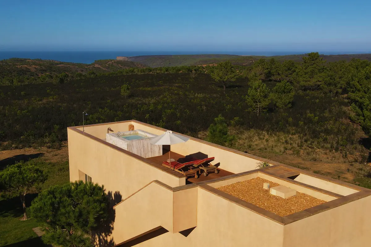 A suite building and its rooftop terrace at Praia do Canal Nature Retreat, with the natural park beyond