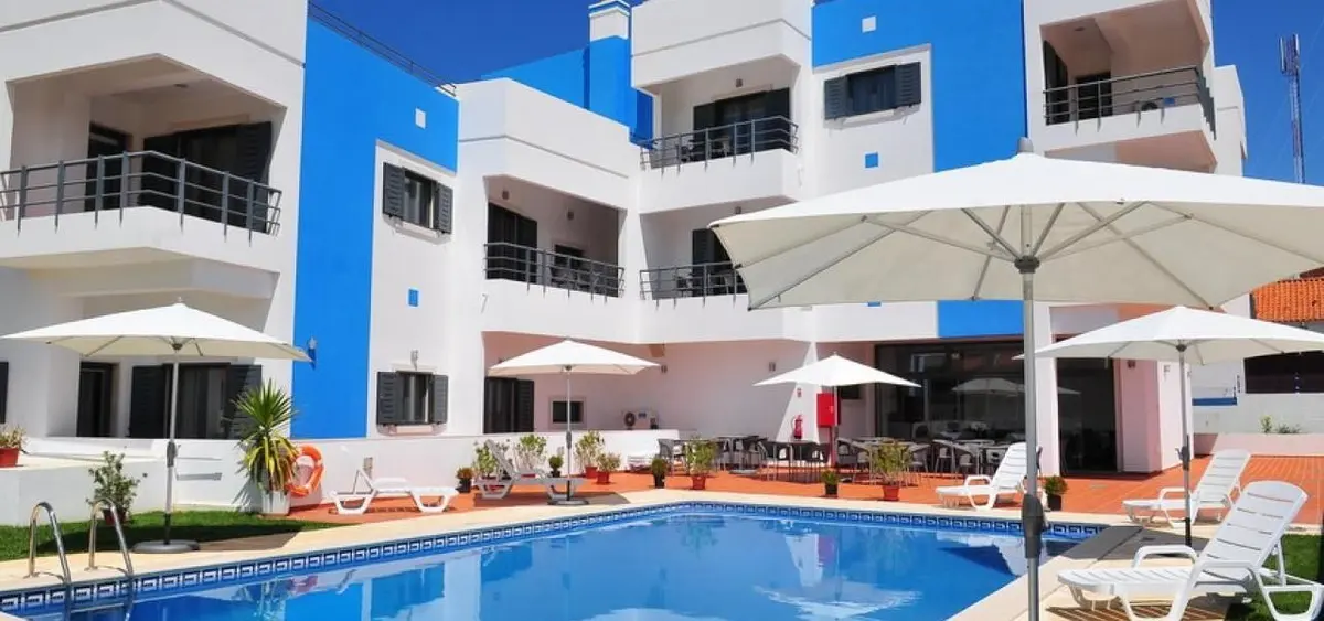 The white hotel buildings and outdoor pool at Vicentina Hotel in Aljezur