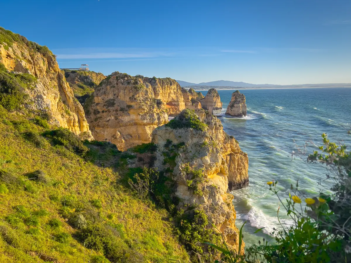 Sunlit golden cliffs and rock stacks at Ponta da Piedade near Lagos