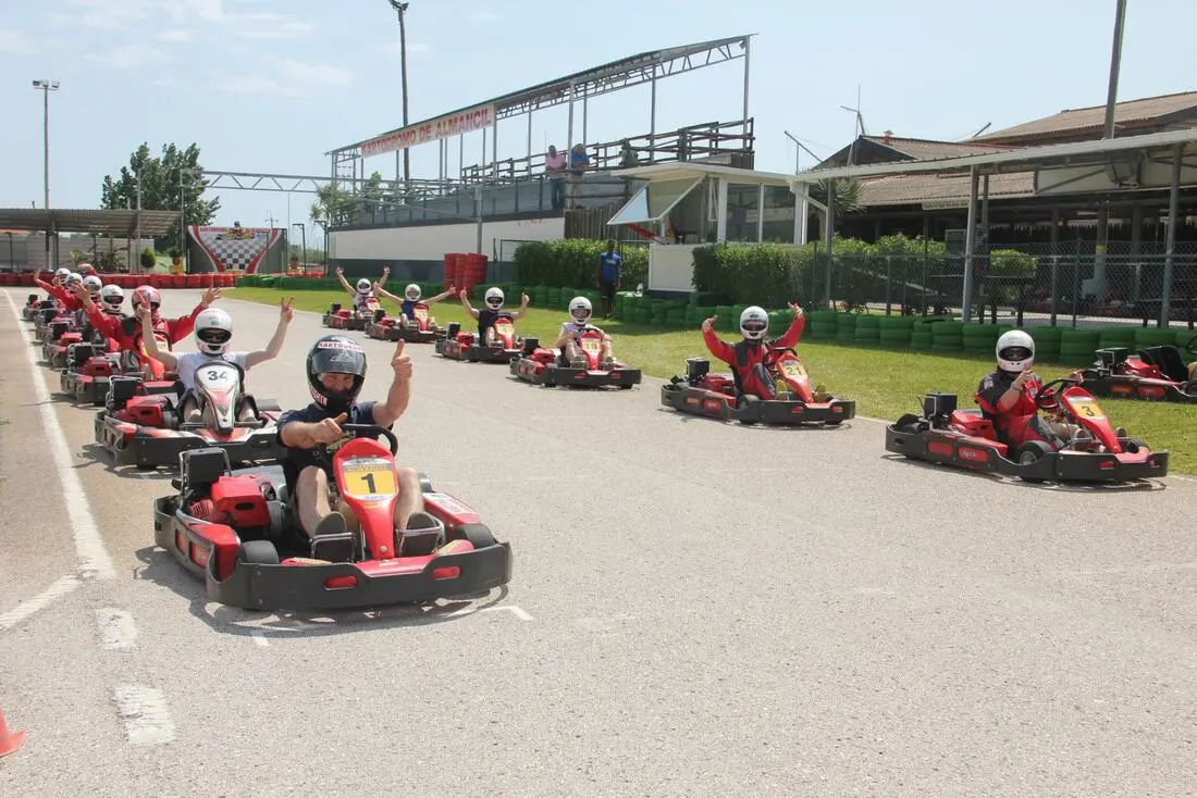 Red go-karts on the outdoor circuit at Karting Almancil