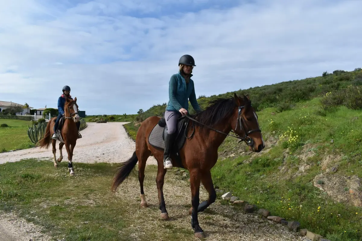 Helmeted riders on horses during a countryside outing with Lagos Horse Riding and Rescue