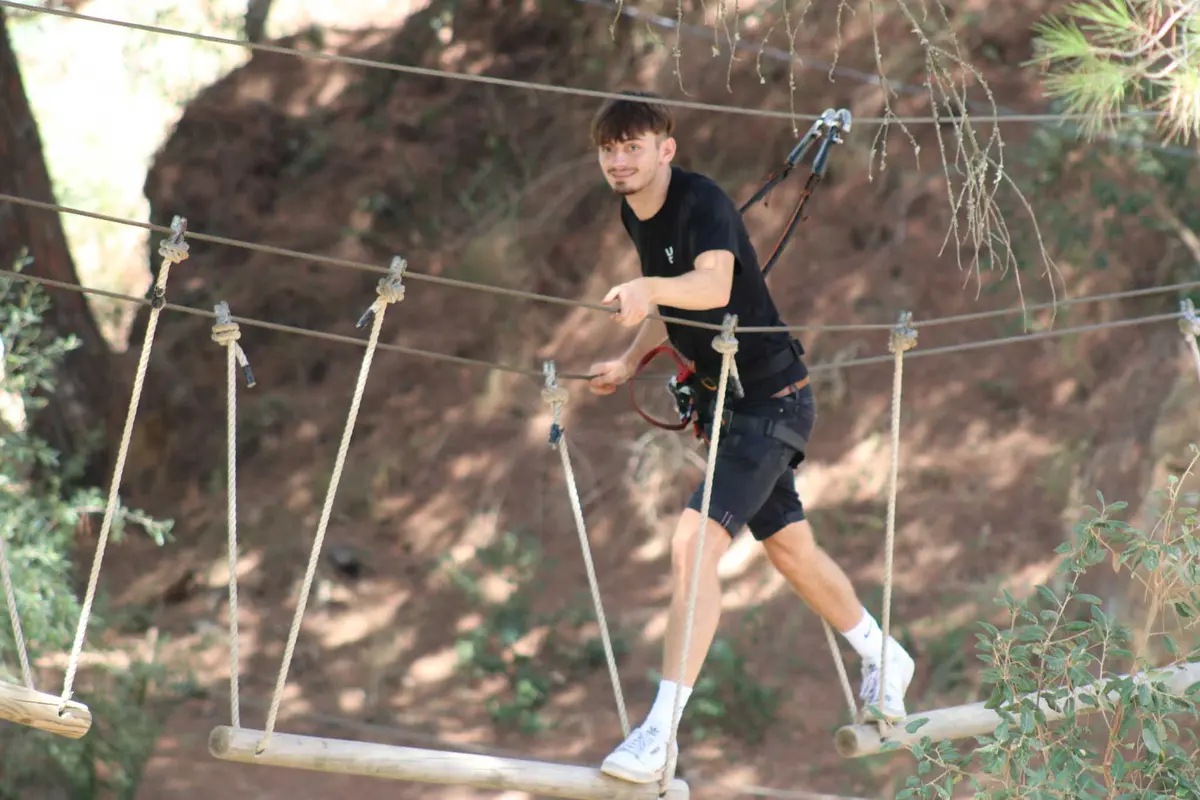 Participant secured to the elevated rope course at Parque Aventura Lagos