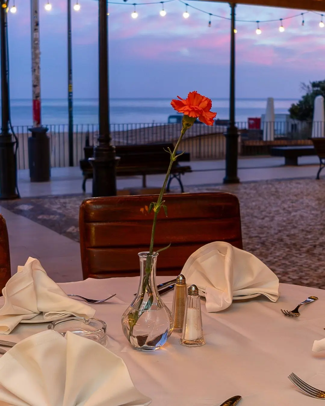 Table overlooking the sea at dusk at Cabana Fresca
