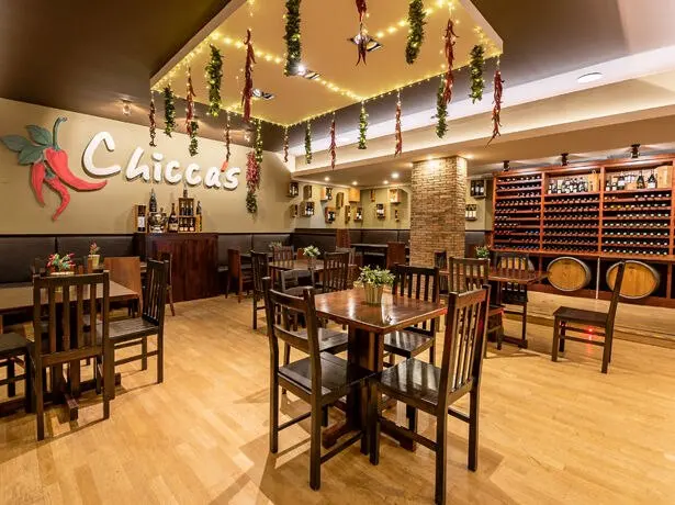 Tables and a bar beneath the Chicca’s sign at Estrela da Luz