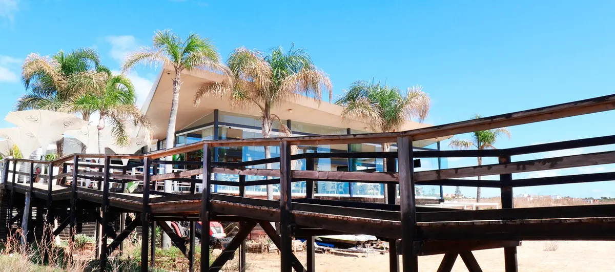 Gaivota Branca’s beach restaurant behind its timber access ramp