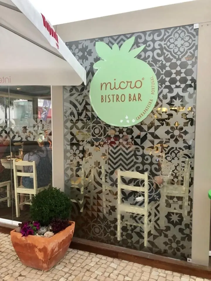 The MicroBistroBar sign and entrance beside patterned tiles and café seating