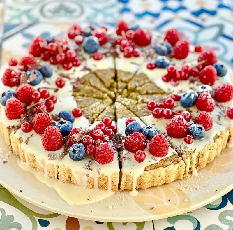 A sliced tart topped with berries in MicroBistroBar’s operator gallery