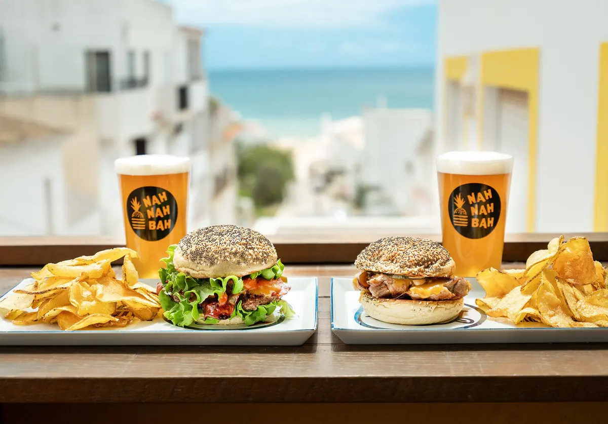 Two Nah Nah Bah burgers with chips and branded drinks, from the operator’s menu photography