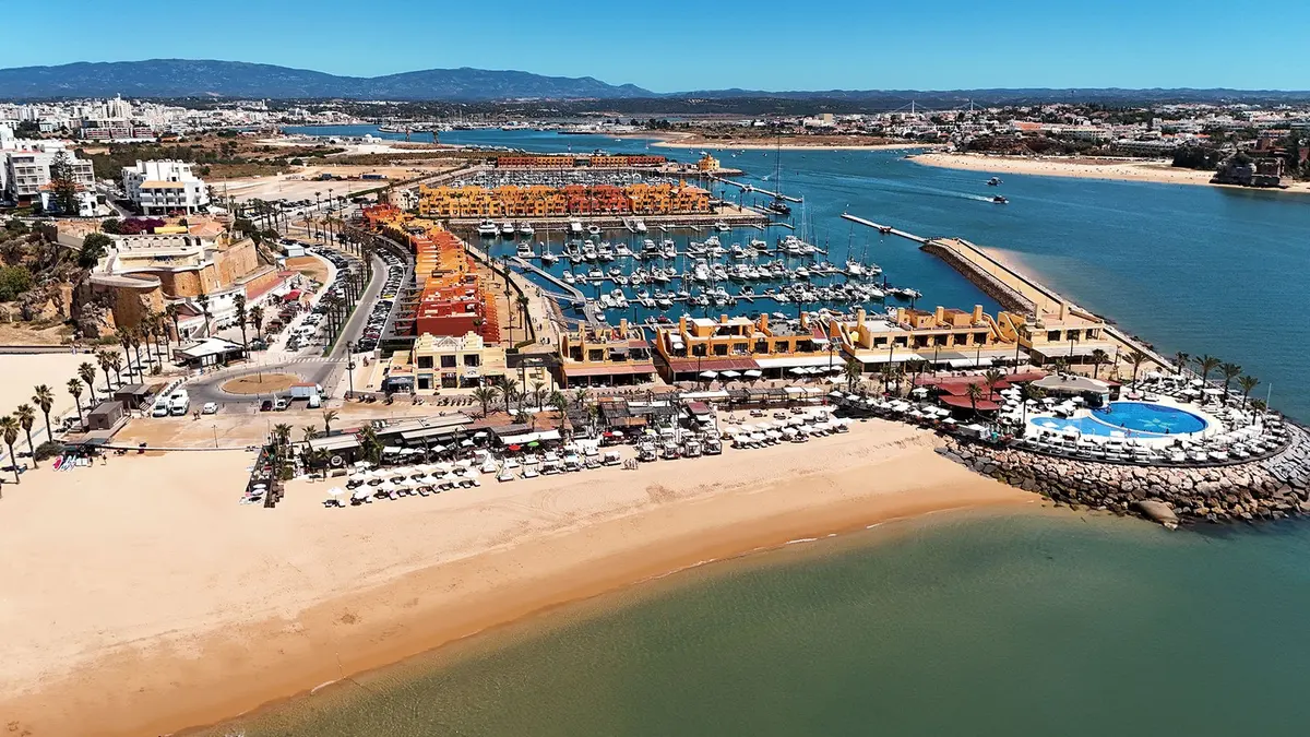 An aerial view of NoSoloÁgua’s beach-club area and the Portimão marina end of Praia da Rocha